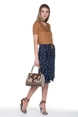 A demure tan pussy bow blouse paired with a navy pencil skirt with circle 